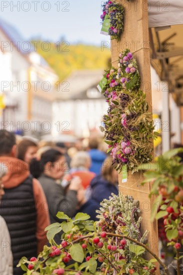 Busy shopping street in autumn, people strolling between modern buildings and colorful shops,