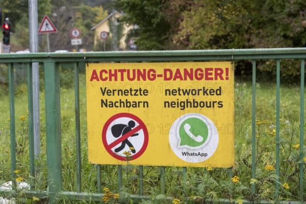 Information sign on neighborhood protection, residents have connected via WhatsApp to warn each