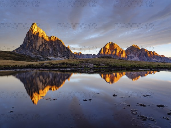 Alpine glow, reflection of the Ra Gusela and Tofane mountains at sunrise, Passo di Giau, Giau Pass,