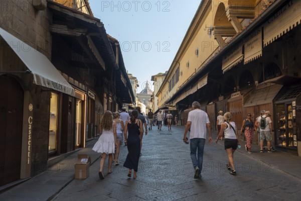 Ponte Vecchio, jewelry stores, dome of Santa Maria del Fiore Cathedral in the background, Florence,