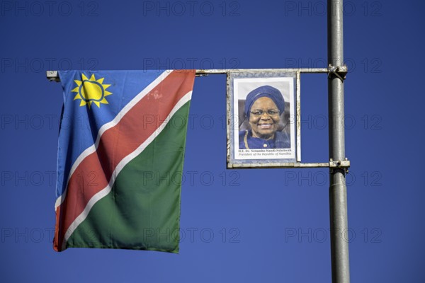 Namibian flag and image of President Dr. Netumbo Nandi-Ndaitwah on a street lamp, Windhoek, Khomas