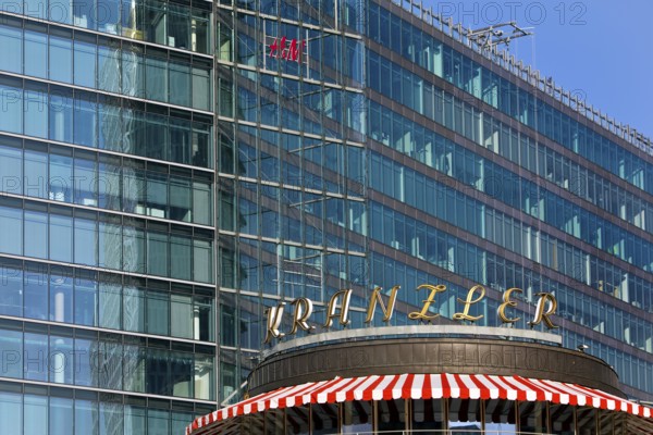 Historic Café Kranzler logo with modern office building and H&M logo on Kurfürstendamm,