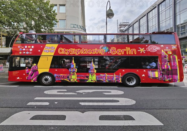 Double-decker bus for the city tour on Tauentzienstraße with Kaiser Wilhelm Memorial Church,