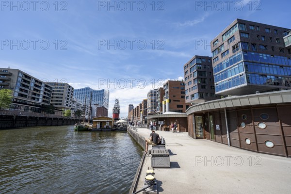 Modern residential buildings, pier at the traditional ship harbor on Sandtorkai, behind