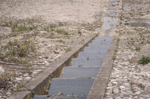 Fish ladder at a waterless body of water, an emptied reservoir, the Metzingen-Glems reservoir,