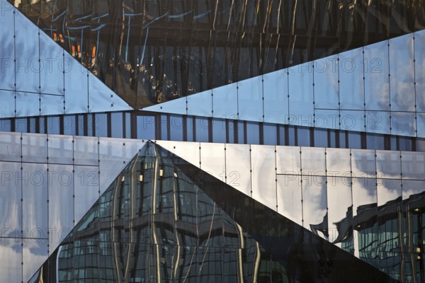 Cube Berlin, cube-shaped office building with folded glass façade reflecting the surroundings,