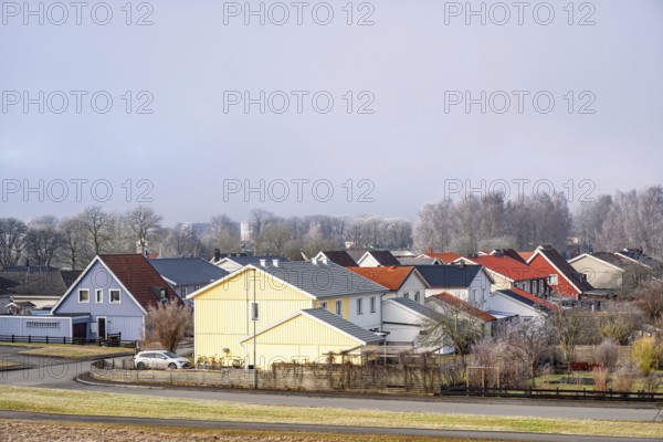 Residential area with detached houses and gardens along streets on a cold winter day, Falköping,