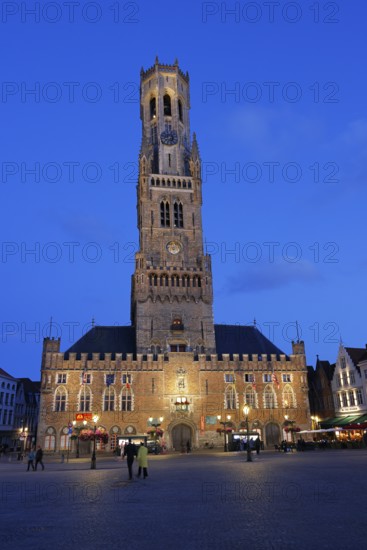 Illuminated Belfry in the historic city centre of Bruges in the evening light, Belfort and City