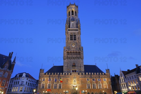 Illuminated Belfry in the historic city centre of Bruges in the evening light, Belfort and City