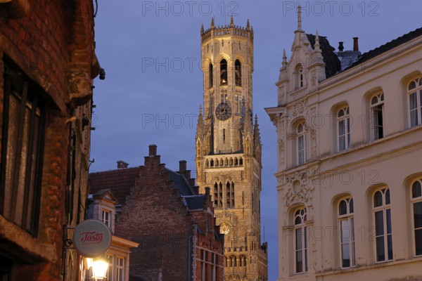 Illuminated Belfry in the historic city centre of Bruges in the evening light, Belfort on the Grote