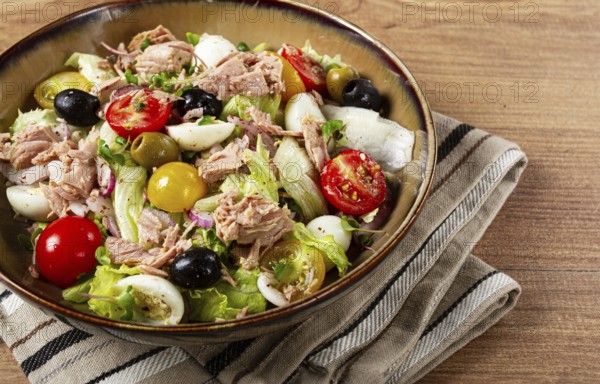 Salad with canned tuna, vegetable salad with quail eggs, lettuce, red onion, cherry tomatoes,