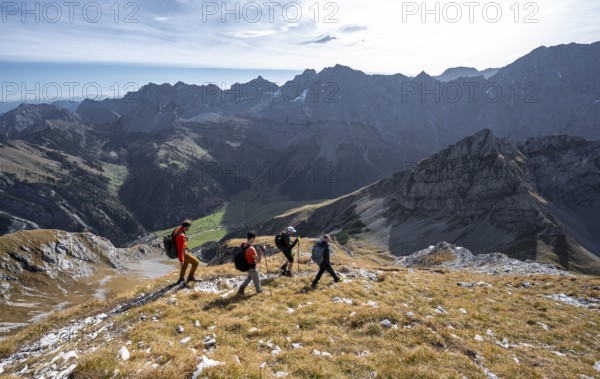 Group of mountaineers descending from the Gamsjoch, in autumn, mountain panorama with
