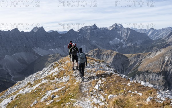 Mountain panorama with picturesque mountain landscape, group of mountaineers descending from the