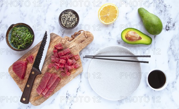 Cooking fresh tuna with ingredients on a marble countertop, ingredients for making sushi and tuna