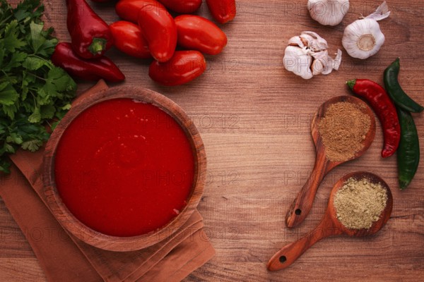 Georgian sauce, Satsebeli sauce, tomato and sweet pepper sauce, with spices, in a wooden bowl,