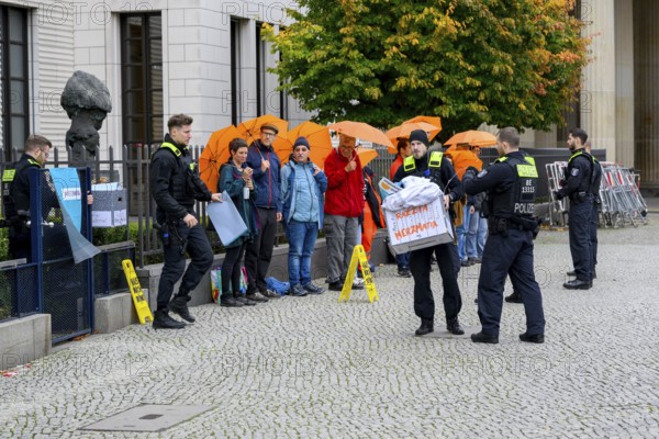 Police officers confiscate boxes from the symbolic house search of the New Generation under the
