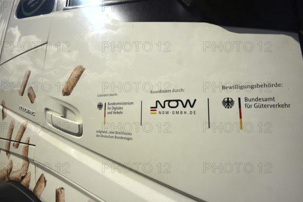 The passenger door of an electric lorry shows which state institutions have paid and approved