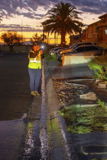 Las Vegas, Nevada - Devyn Choltko, a water waste investigator, patrols a residential neighborhood,