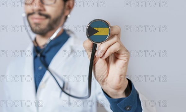 Doctor holding stethoscope with Bahamas flag. Bahamas health and care concept. Bahamas flag on