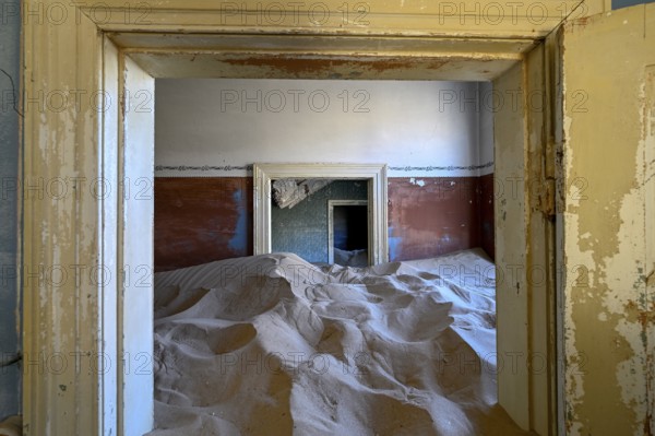 Sand mountains in a former dwelling house, interior photograph, Kolmanskop, restricted diamond