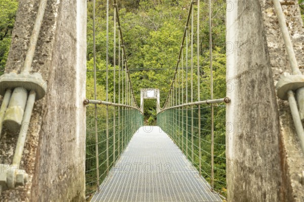 Metal suspension bridge crossing the sella river, connecting the dobra river route with the olla de