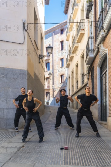 Group of diverse young adults expressing themselves through dynamic street dance movements on a