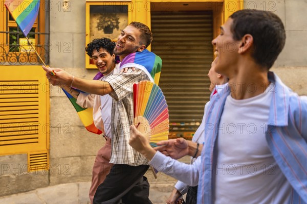 Happy men are walking together on a street during a pride event, holding a small rainbow flag and a