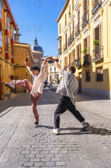 Two energetic young men performing a street dance on a cobblestone street in a lively european