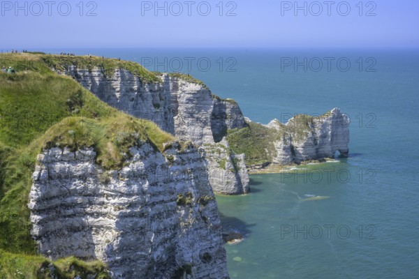 View of the Falaise d'Amont rock arch, hike from Yport to Etretat along the chalk cliff coast,
