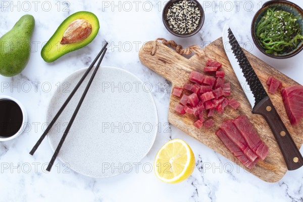 Cooking fresh tuna with ingredients on a marble countertop, ingredients for making sushi and tuna