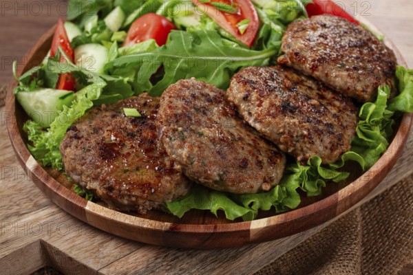 Fried cutlets, mixed minced meat, with vegetable salad, homemade, top view, no people