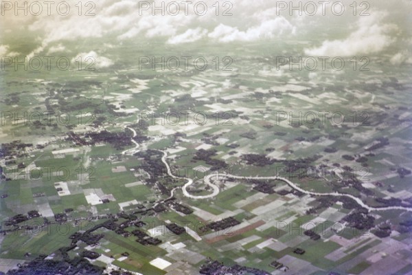 Captioned as 'aerial photo Saigon', meandering river in flat agricultural landscape of paddy