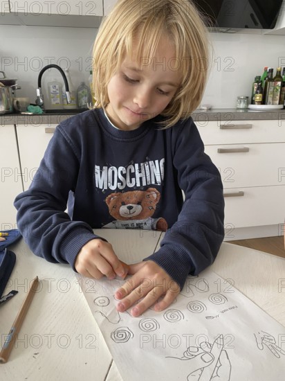 Boy, 6 years, blond, 1st grade, erasing, doing homework in the kitchen, pencil case, Stuttgart,