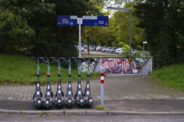 Several e-scooters, electric scooters, scooters parked on the pavement, pavement, in the Bolt bike