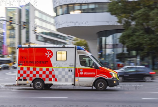 Ambulance of the BOS organisation Johanniter in an urban environment. Pull along. Stuttgart,