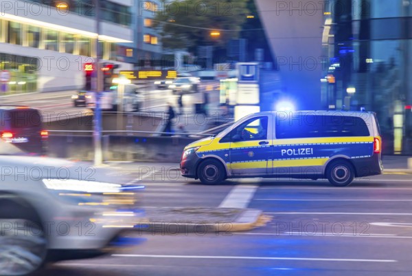 Police vehicle with flashing blue lights in an urban environment. Pulling along. Stuttgart,