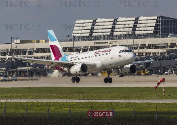 Flight operations at Stuttgart Airport with terminal. Aircraft on landing. Aircraft registration