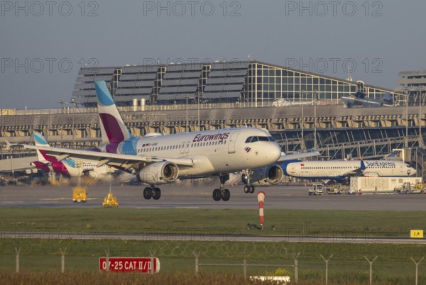Flight operations at Stuttgart Airport with terminal. Aircraft on landing. Aircraft registration