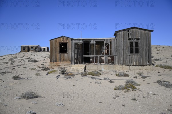 Dilapidated building in the desert sand, Pomona, restricted diamond area, near Lüderitz, Karas