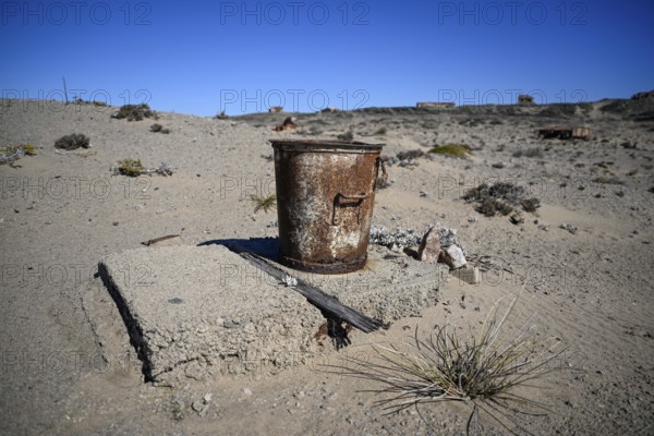 Rusted bucket in the desert sand, Pomona, restricted diamond area, near Lüderitz, Karas region,