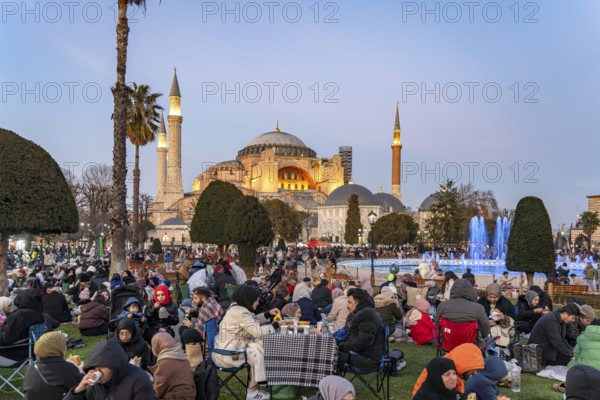 Muslims at an evening Ramadan picnic in the park in front of the Hagia Sophia mosque in Istanbul,