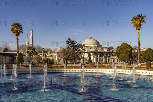 Fountain in Sultan Ahmet Park and the Sultanahmet Madrasa in Istanbul, Turkey
