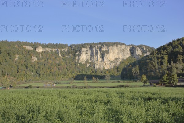 Railway line with train and view of rock formations, landscape, rock formations, rock cliffs,