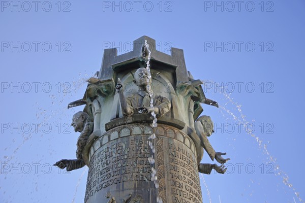 Town hall fountain by Klaus Ringwald 1998, bronze sculptures, reliefs, figures and text on the