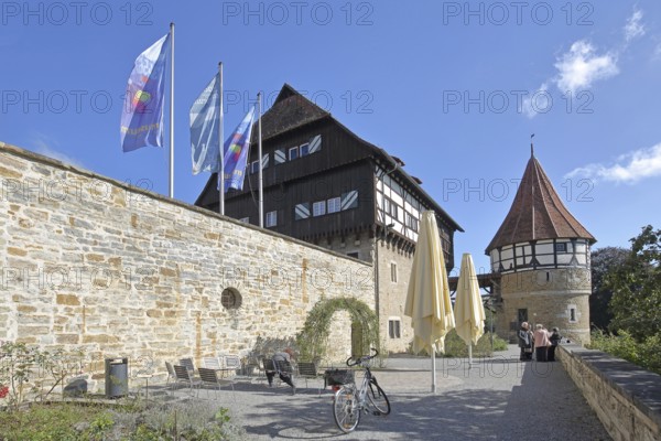 Water tower of the medieval Zollern castle built around 1255, half-timbered house, flags, stone