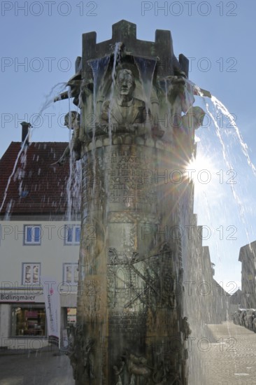 Town hall fountain with reliefs and figures by Klaus Ringwald 1998 in backlight, bronze sculptures,