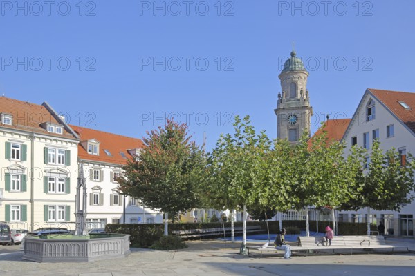 Obertorplatz with church tower of the collegiate church of St James, benches, people sitting,