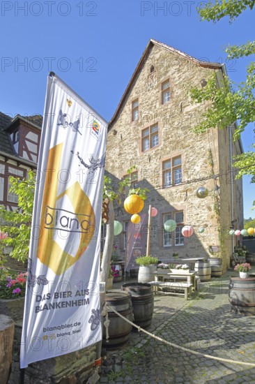 Banner with beer brand, lanterns and courtyard with wine barrels, flag, inscription, Blankenheim,