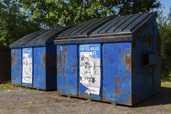 Blue metal with black plastic lid industrial size recycling bins for depositing glass, metal and