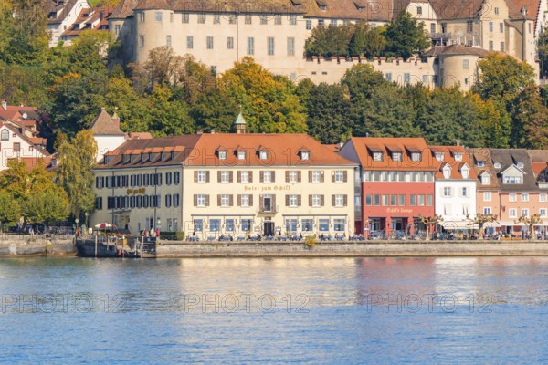 Historic buildings on the lakeshore with autumnal vegetation in the background, Meersburg, Lake